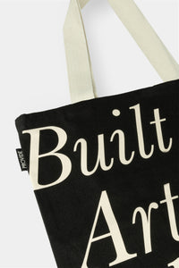 Provide Built on Art and Industry black Tote Bag with hand logo (close up)