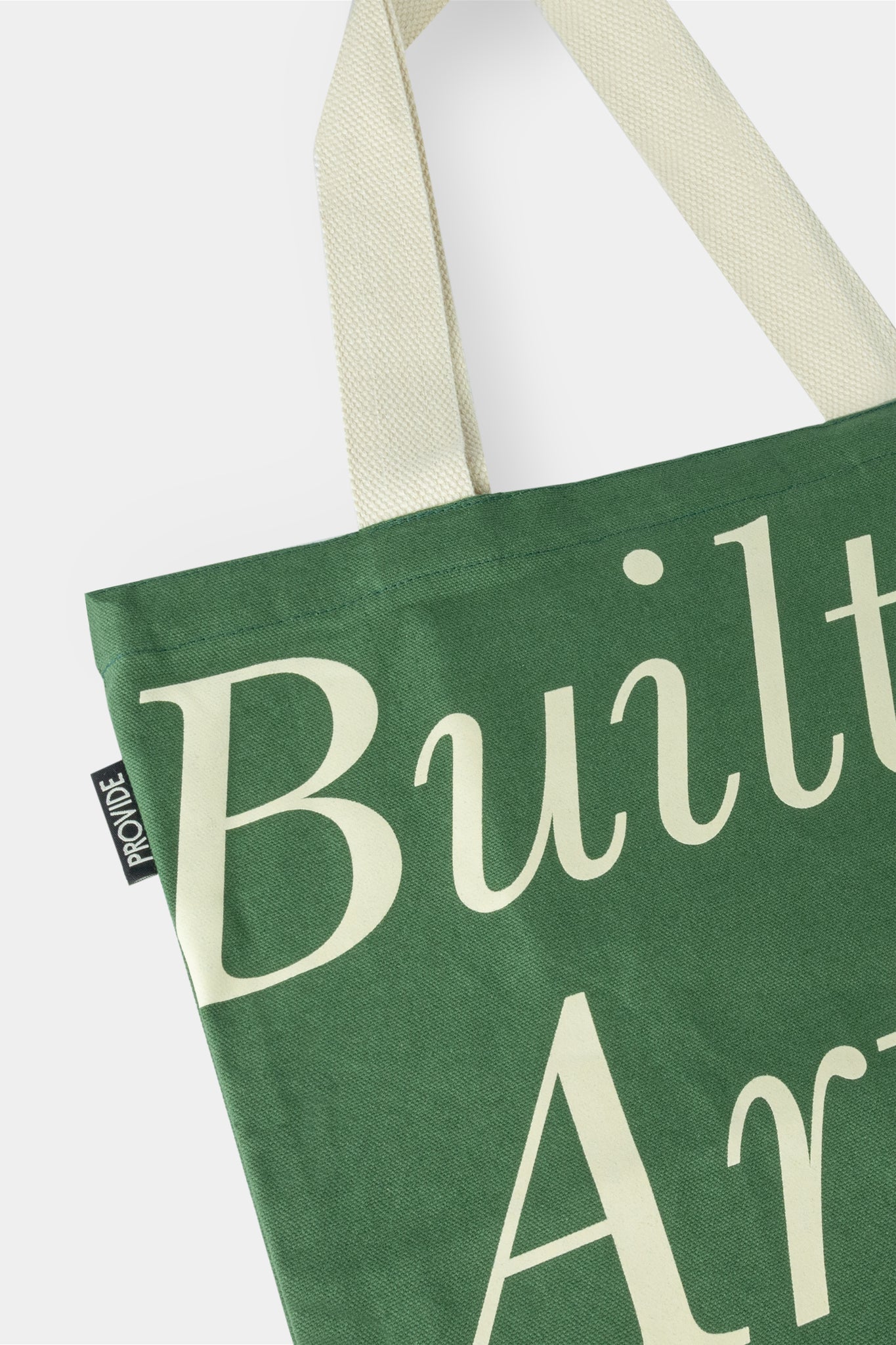 Provide Built on Art and Industry green Tote Bag with hand logo (close up)