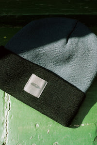 Provide black and grey beanie with hand logo patch stitched on to front (front)
