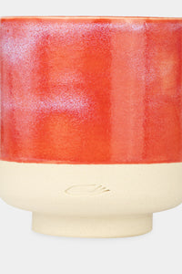 Provide red glazed ceramic candle with hand logo imprint (close up)