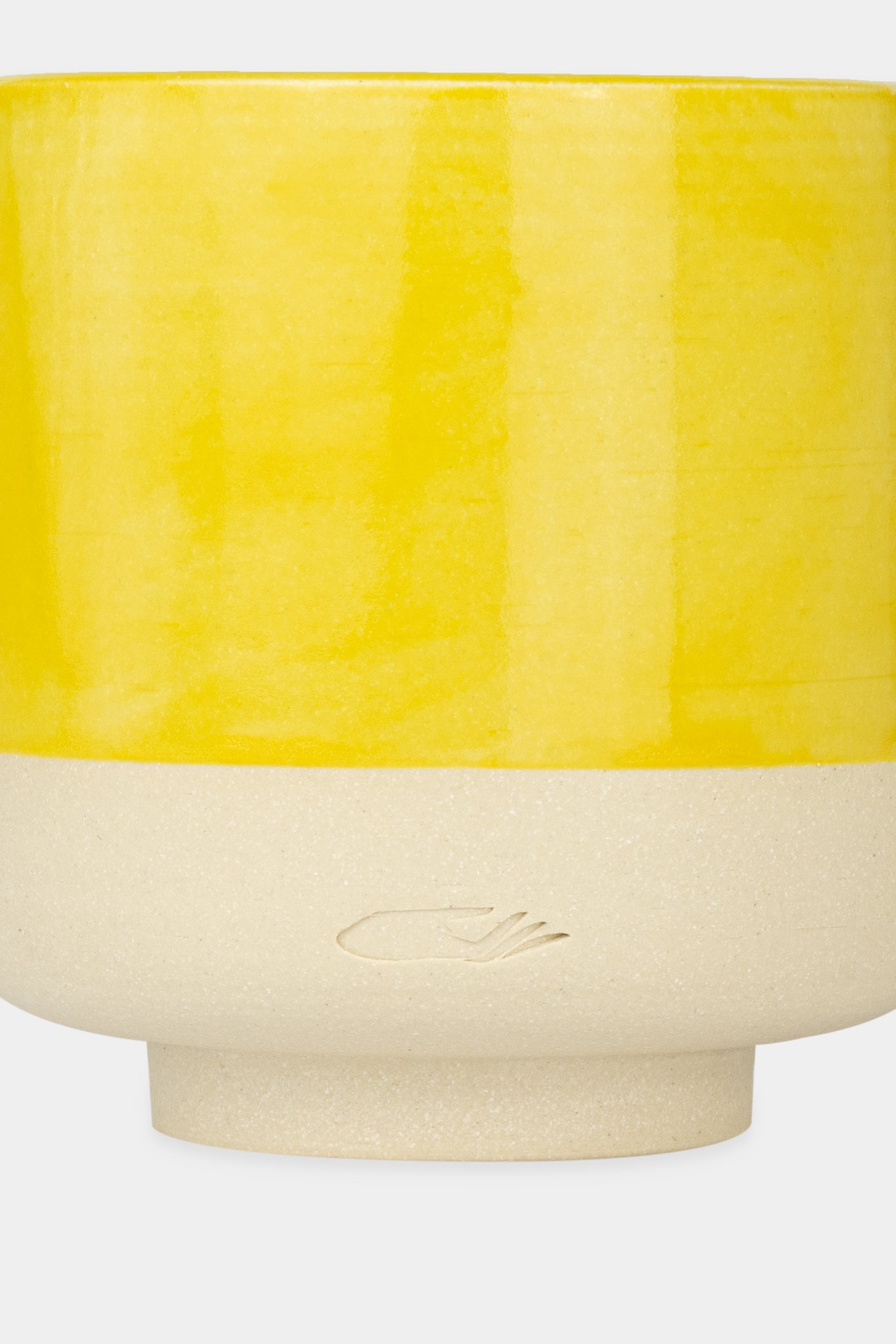 Provide yellow glazed ceramic candle with hand logo imprint (close up)