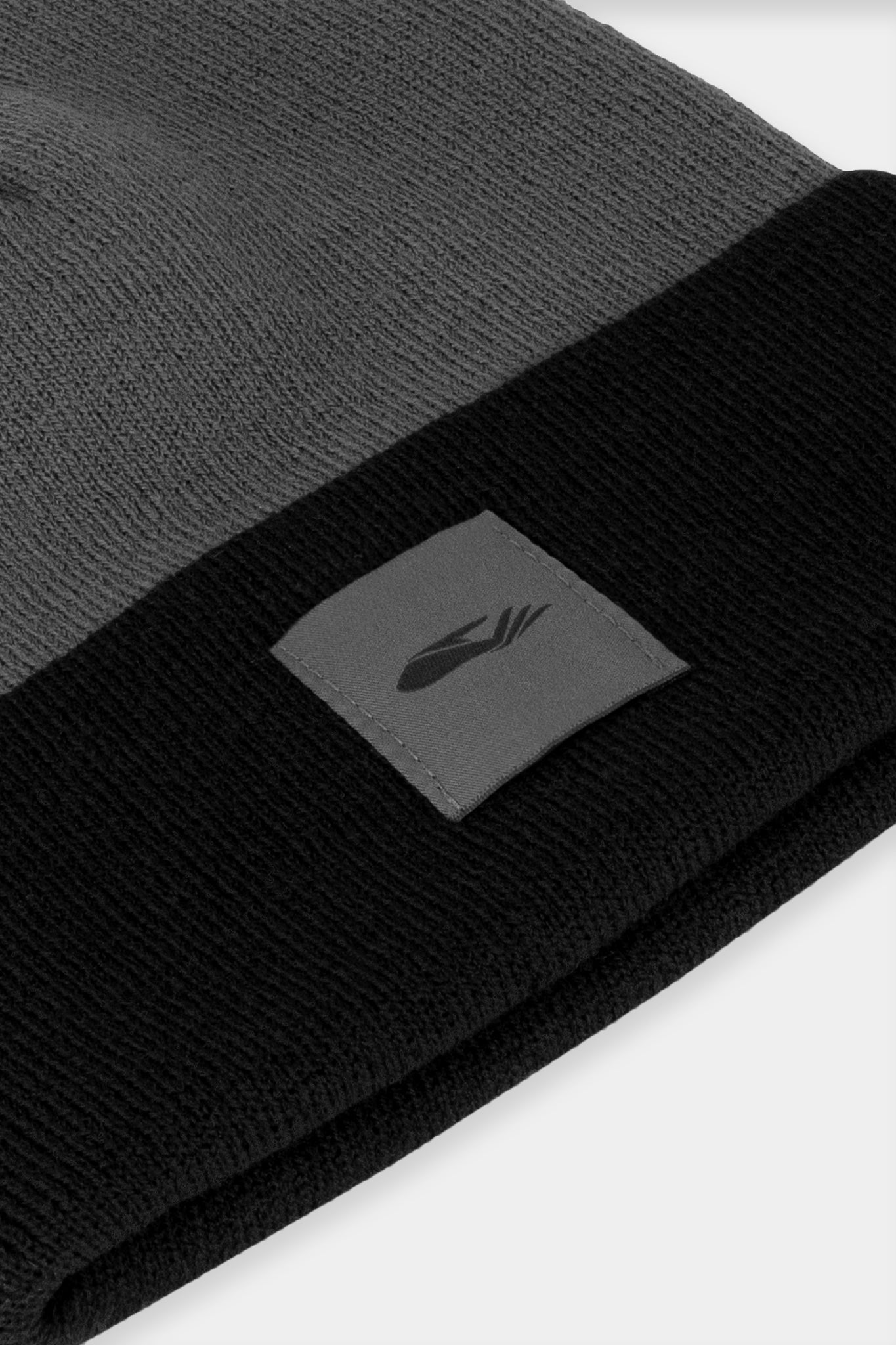 Provide black and grey beanie with hand logo patch stitched on to front (close up)