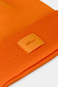 Provide orange beanie with hand logo patch stitched on to front (close up)