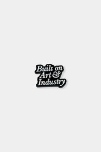 Provide Built on Art and Industry enamel pin badge in white and black