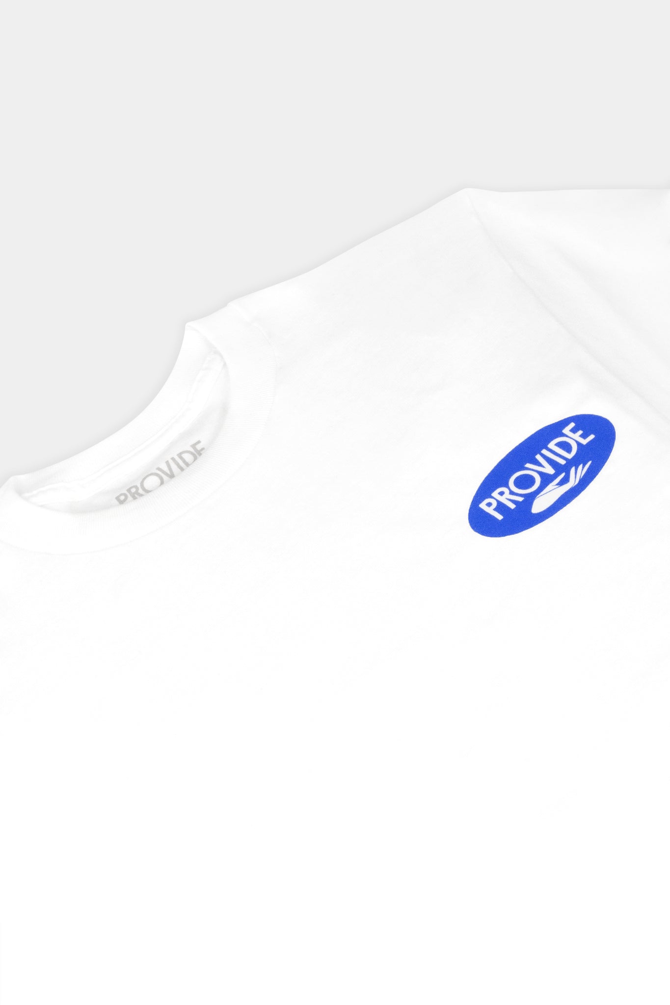 Provide white Tee with blue oval hand logo on right chest (close up)