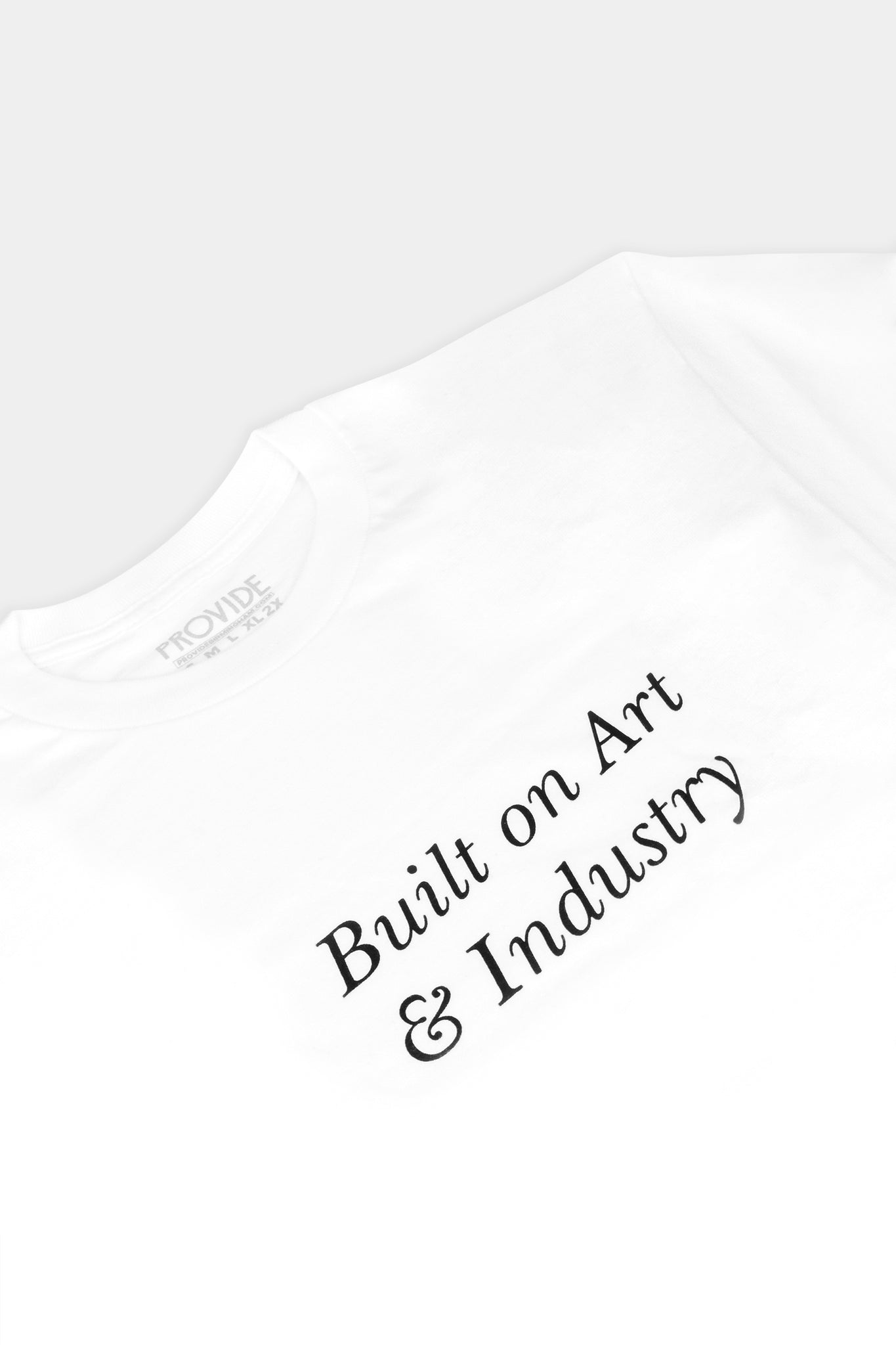 Provide white Tee with large Built on Art and Industry chest print (close up)
